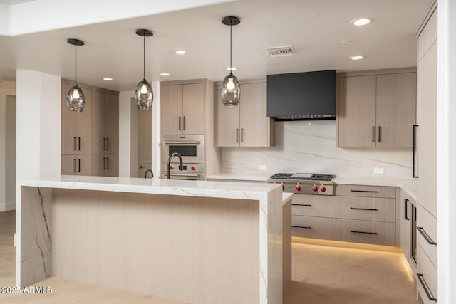 kitchen featuring backsplash, light brown cabinets, and wall chimney exhaust hood