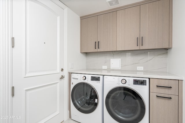 washroom with cabinets and separate washer and dryer