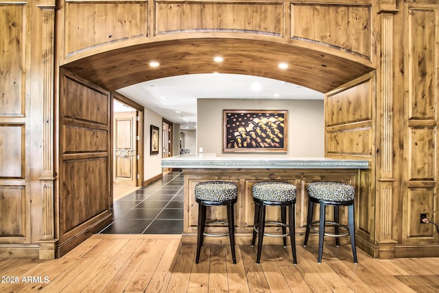 bar with dark hardwood / wood-style floors