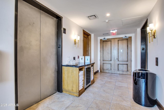 interior space featuring beverage cooler and elevator