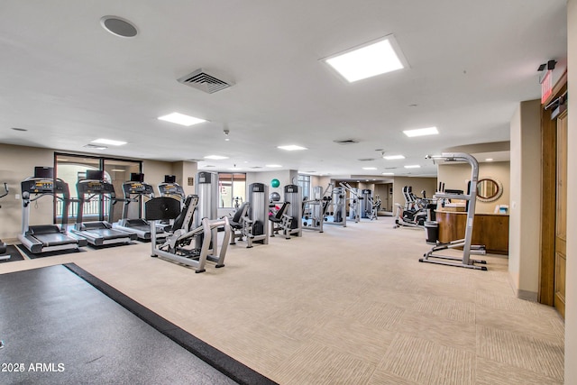 workout area featuring light carpet