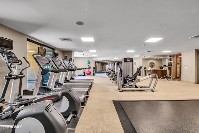 exercise room with light carpet