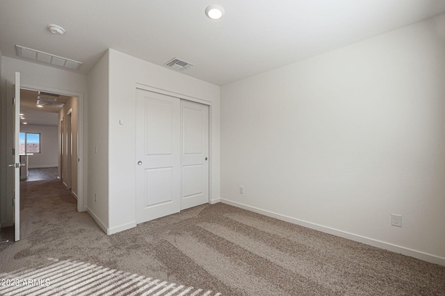 unfurnished bedroom with carpet flooring and a closet