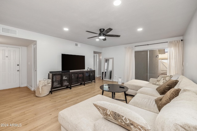 living room featuring light hardwood / wood-style flooring and ceiling fan