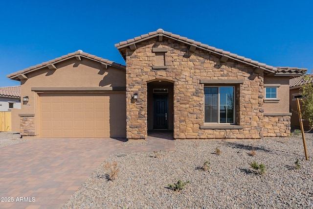 18950 W Ocotillo Rd, Waddell, AZ 85355 - view of front facade with stone siding, a tile roof, decorative driveway, and a garage
