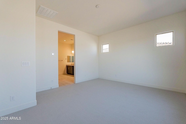 18950 W Ocotillo Rd, Waddell, AZ 85355 - unfurnished room featuring visible vents, baseboards, and light carpet