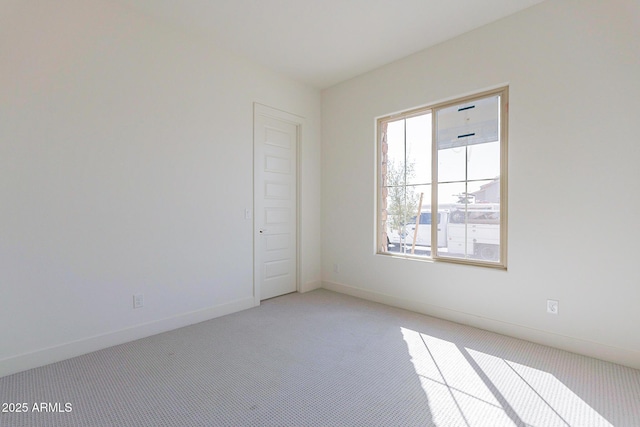 18950 W Ocotillo Rd, Waddell, AZ 85355 - spare room featuring baseboards and light carpet