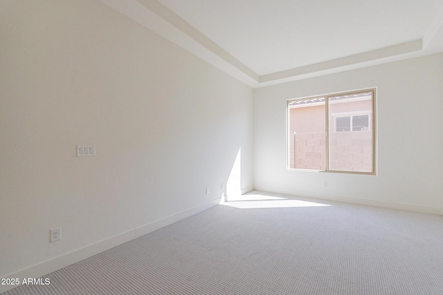 18950 W Ocotillo Rd, Waddell, AZ 85355 - spare room with a raised ceiling, carpet floors, and baseboards