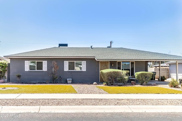 single story home with roof with shingles and a front lawn
