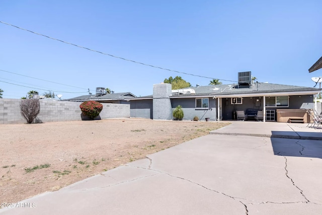 exterior space with a patio area, fence, and central AC unit