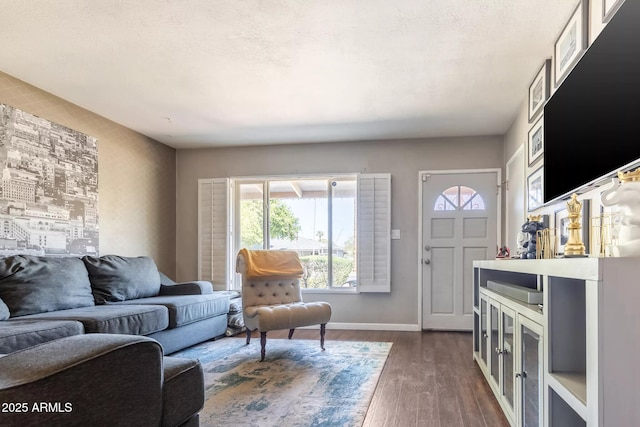 living room featuring dark wood-style flooring, baseboards, and plenty of natural light