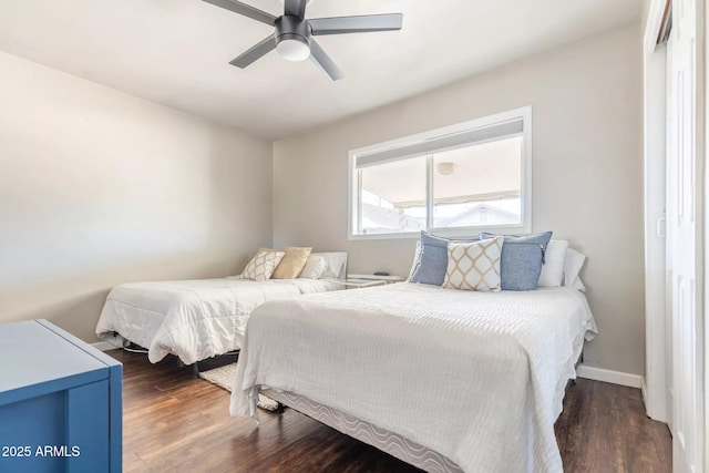 bedroom with wood finished floors, baseboards, and a ceiling fan