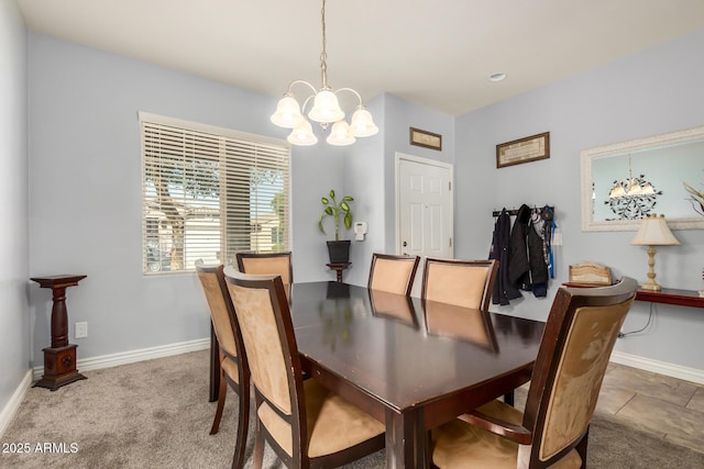 carpeted dining space with an inviting chandelier and baseboards