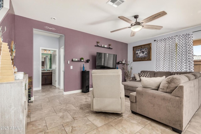 living room with visible vents, baseboards, and ceiling fan