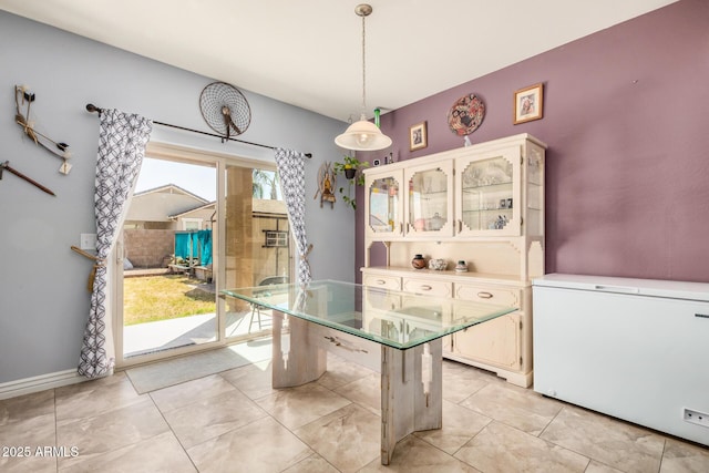 unfurnished dining area featuring baseboards