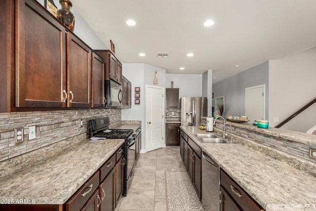 kitchen featuring recessed lighting, backsplash, a sink, visible vents, and black appliances