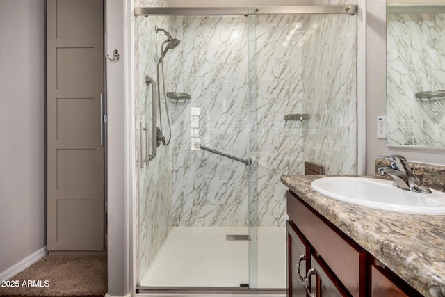 bathroom with vanity and a marble finish shower