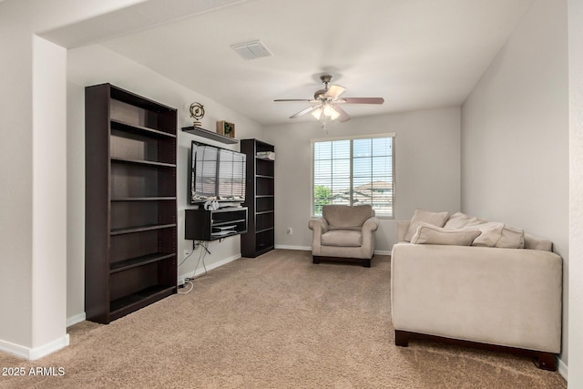 sitting room with baseboards, visible vents, carpet floors, and a ceiling fan