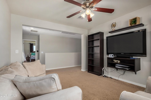 living room with baseboards, carpet floors, visible vents, and a ceiling fan