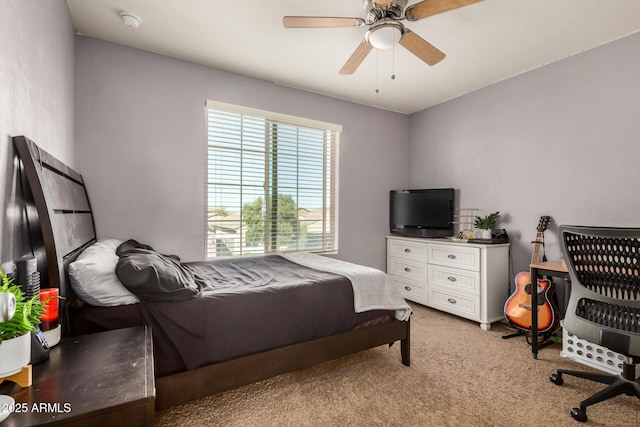bedroom with light colored carpet and a ceiling fan