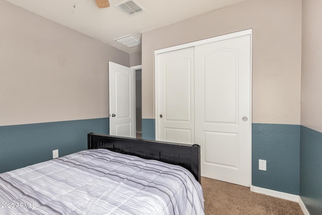 carpeted bedroom with baseboards, visible vents, and a closet