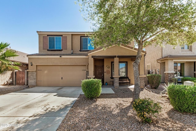 traditional-style home featuring stucco siding, a garage, concrete driveway, and fence