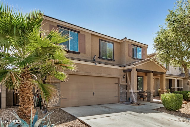 view of front of property featuring stucco siding, an attached garage, and concrete driveway