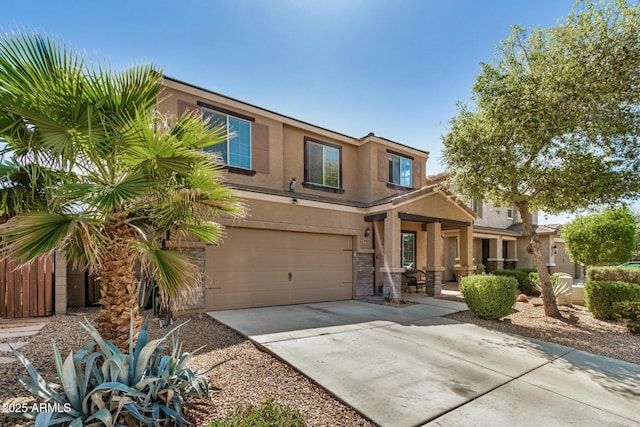view of front facade with stucco siding, driveway, stone siding, and an attached garage