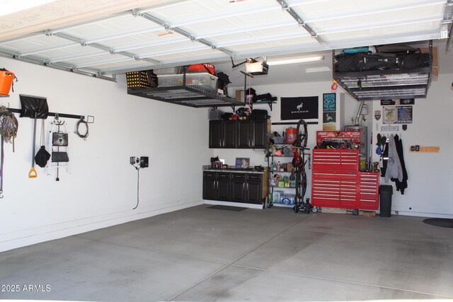 garage featuring a garage door opener and a workshop area