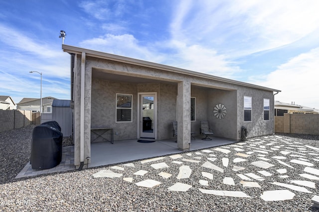 back of property with a patio