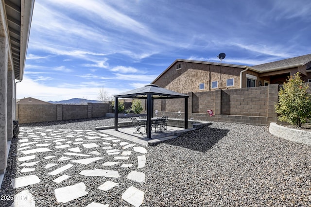 view of patio featuring a gazebo and a mountain view