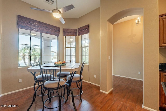 dining area featuring dark wood-style flooring, visible vents, and baseboards