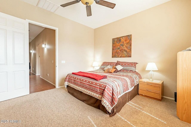 carpeted bedroom with ceiling fan, visible vents, and baseboards