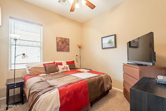 bedroom with light carpet, baseboards, visible vents, and ceiling fan