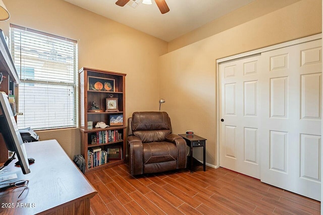 home office with a ceiling fan and wood tiled floor