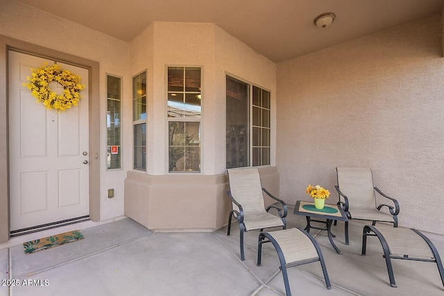 property entrance featuring stucco siding