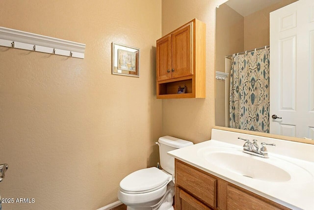 bathroom with vanity, toilet, and a shower with curtain