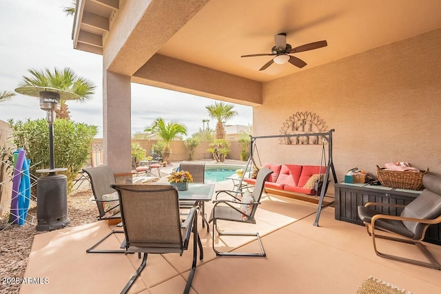 view of patio / terrace featuring a ceiling fan, outdoor dining area, a fenced backyard, and a fenced in pool