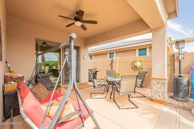 view of patio / terrace with ceiling fan, fence, and outdoor dining space