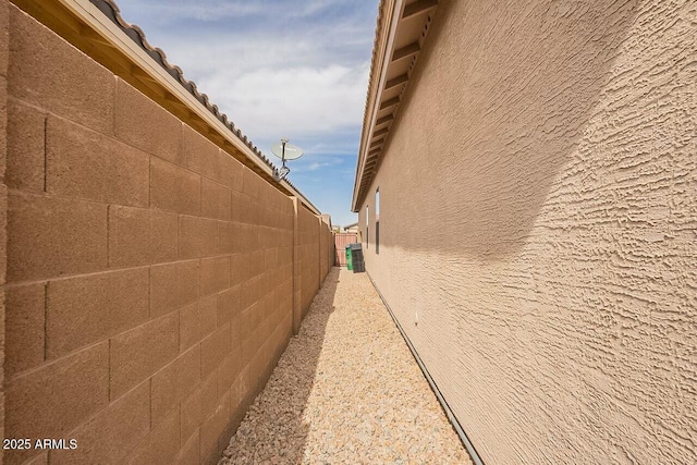 view of property exterior featuring fence and stucco siding