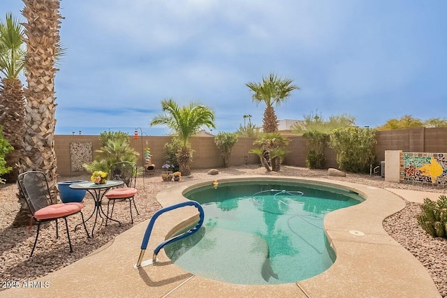 view of pool with a fenced backyard