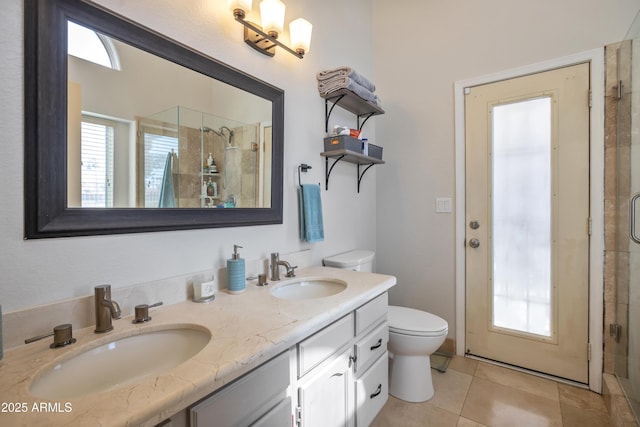 full bath featuring toilet, a shower stall, double vanity, and a sink