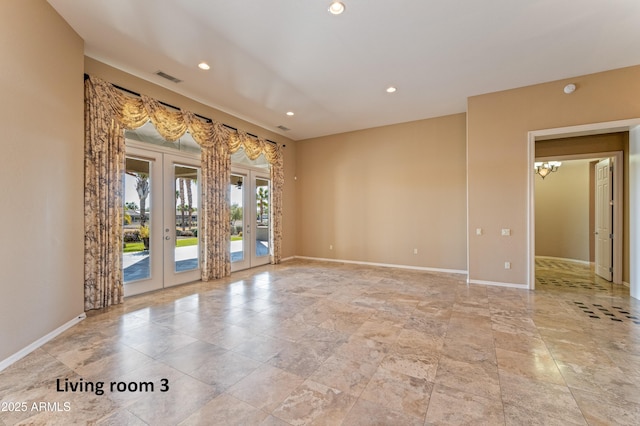 unfurnished room featuring french doors