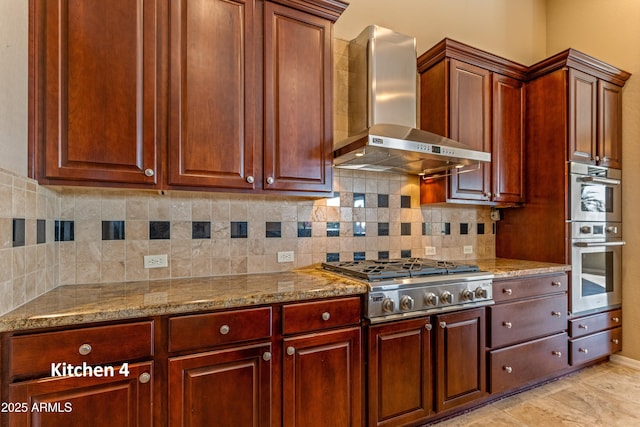 kitchen with appliances with stainless steel finishes, wall chimney exhaust hood, backsplash, and light stone countertops