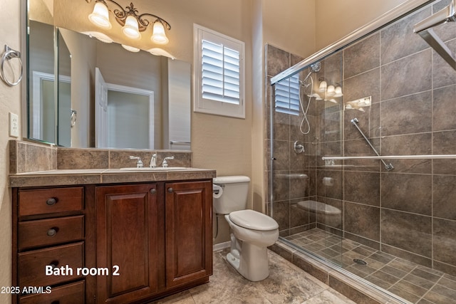 bathroom with toilet, a shower with door, and vanity