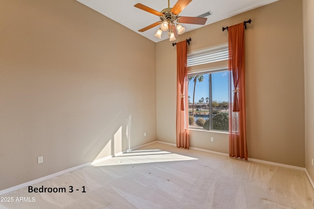 carpeted spare room with ceiling fan and a water view