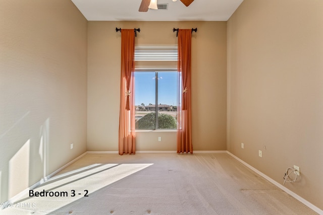 unfurnished room featuring ceiling fan and carpet floors