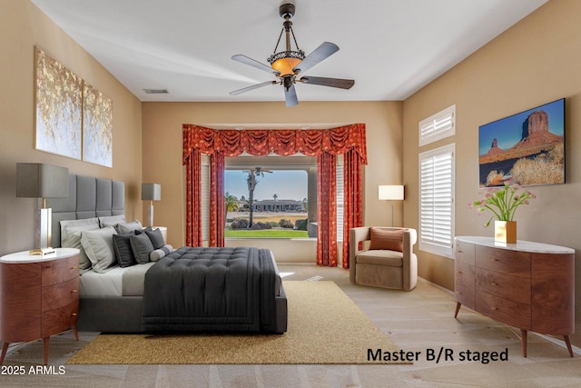 bedroom featuring ceiling fan and multiple windows