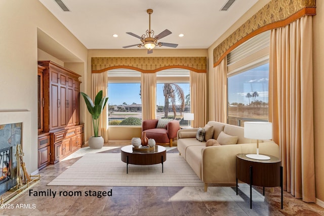 interior space with ceiling fan and a high end fireplace