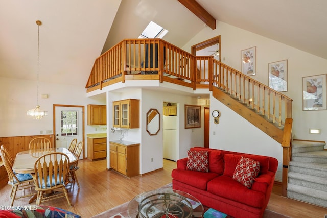 9434 W Obier Dr, Pine, AZ 85544 - living area featuring stairway, light wood-type flooring, high vaulted ceiling, beam ceiling, and a skylight